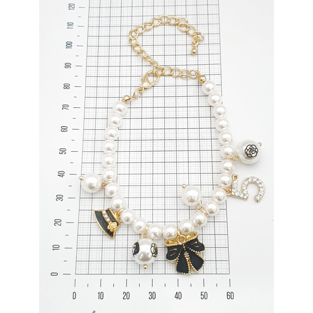 Elegant Pearl Bracelet with Black & Gold Charms