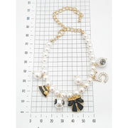 Elegant Pearl Bracelet with Black & Gold Charms