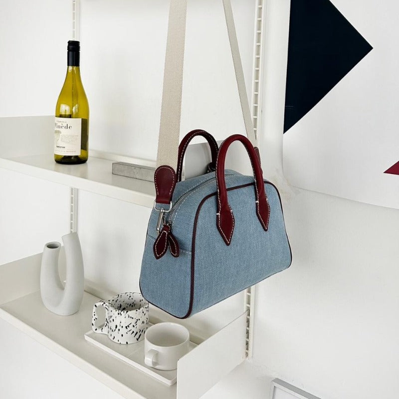 dome-shaped handbag with a cream canvas body and dark brown leather handles