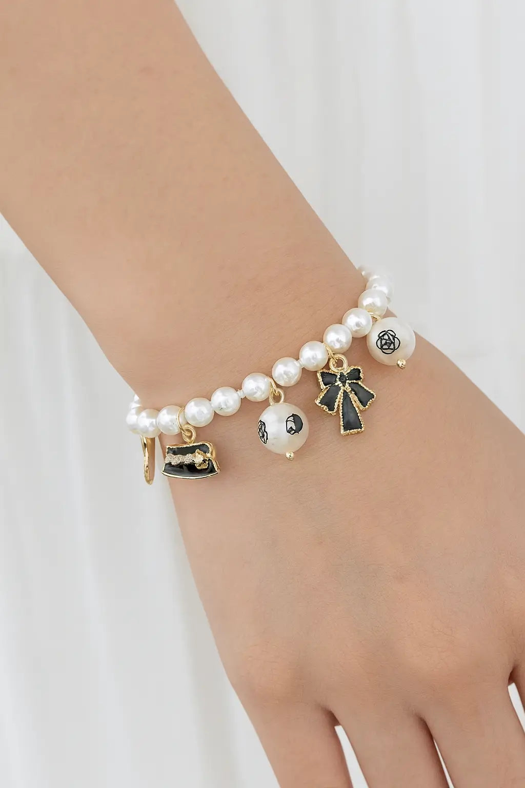 Elegant Pearl Bracelet with Black & Gold Charms