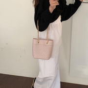 Elegant Pink woven leather bag with gold chain strap.
