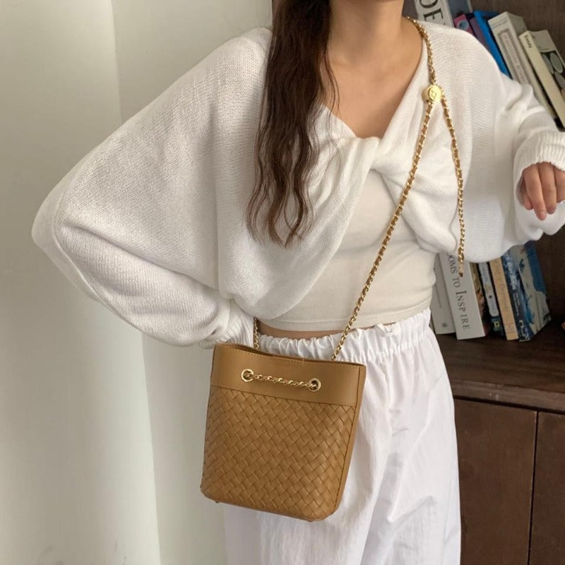 Elegant Pink woven leather bag with gold chain strap.