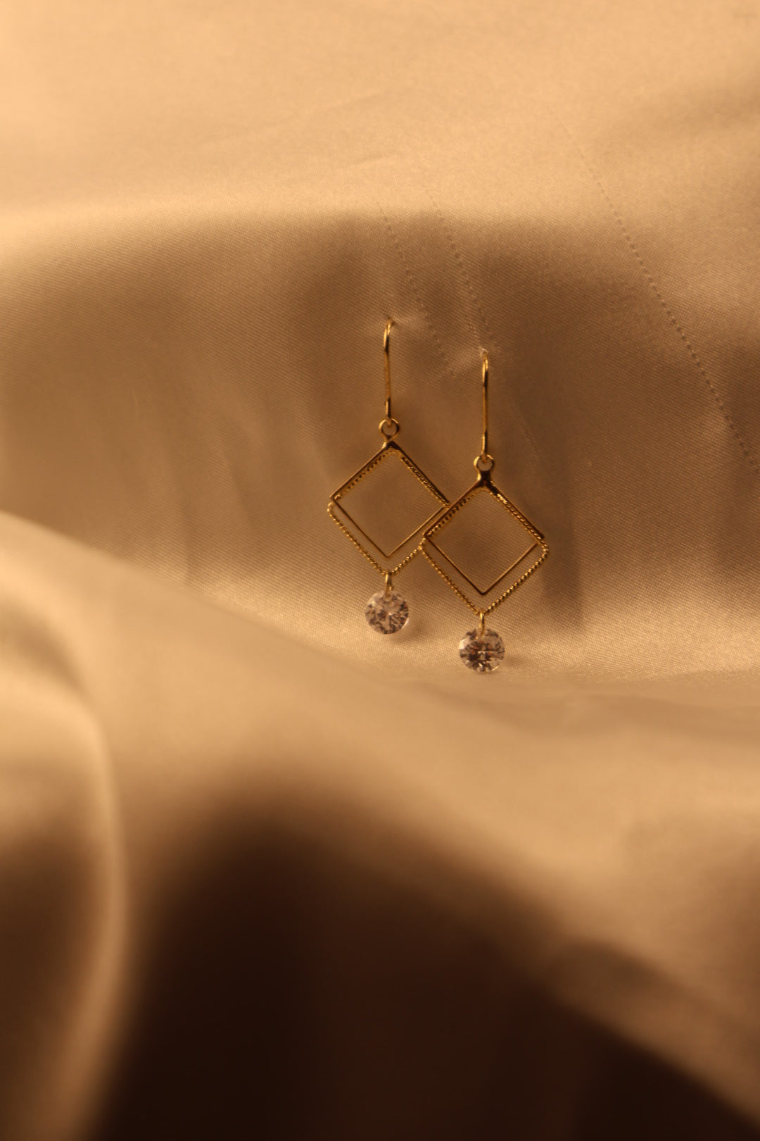 gold square with stone hanging